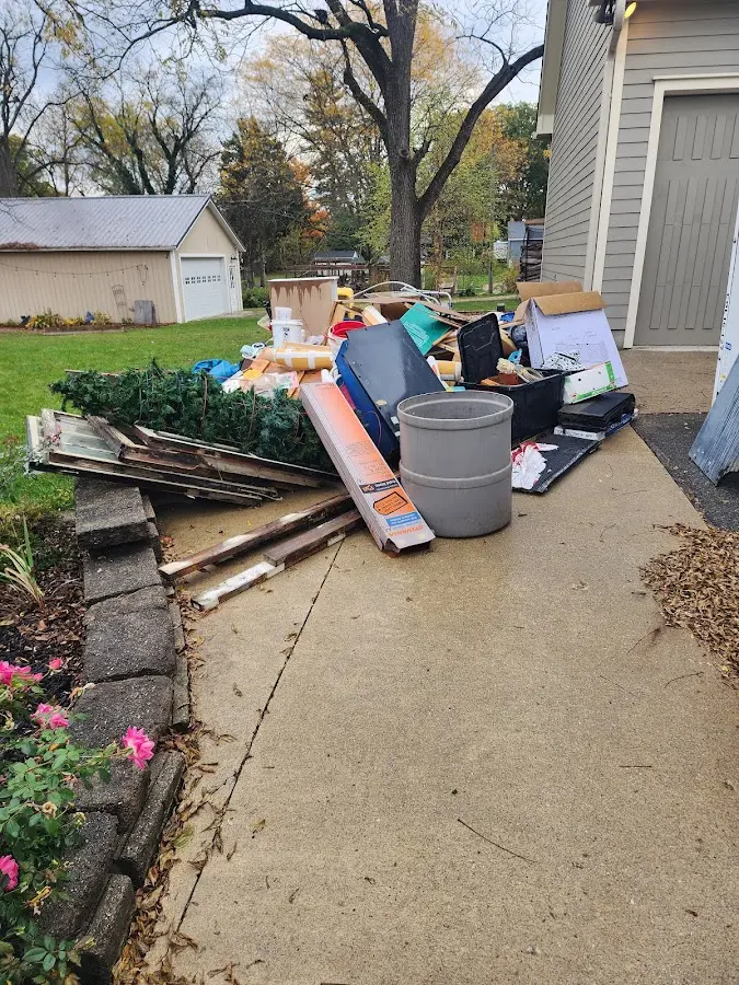 Dumpster being loaded with debris for 12 Yard Dumpster Rental in Wheatland